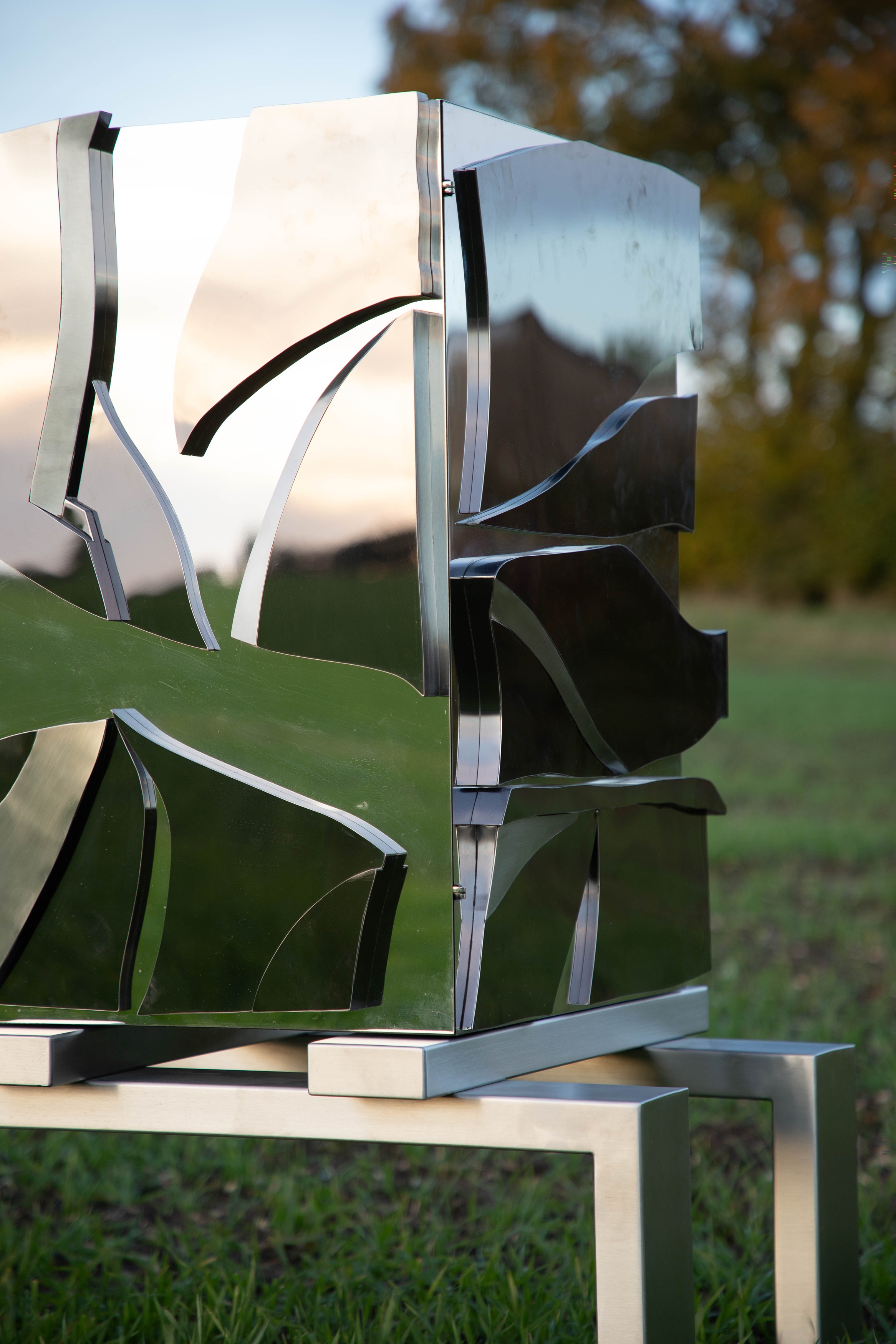 Maria Pergay (French, 1930-2023) Broken Cabinet, 2007, a sculptural stainless steel side cabinet, the two cabinet sections set with faceted and polished stainless steel sheets, raised on a stretcher, from an edition of 8, 155cm wide 57.5cm deep 106.5cm high (£12,000-15,000)